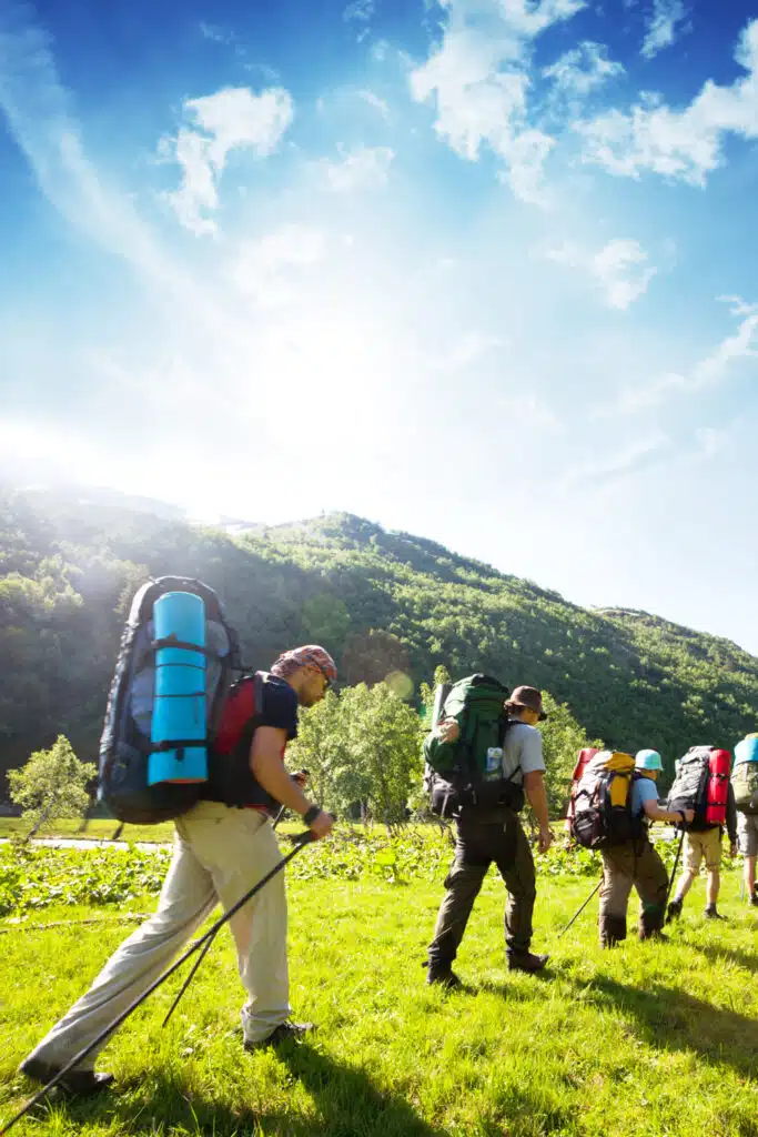 carrying heavy packs trekking