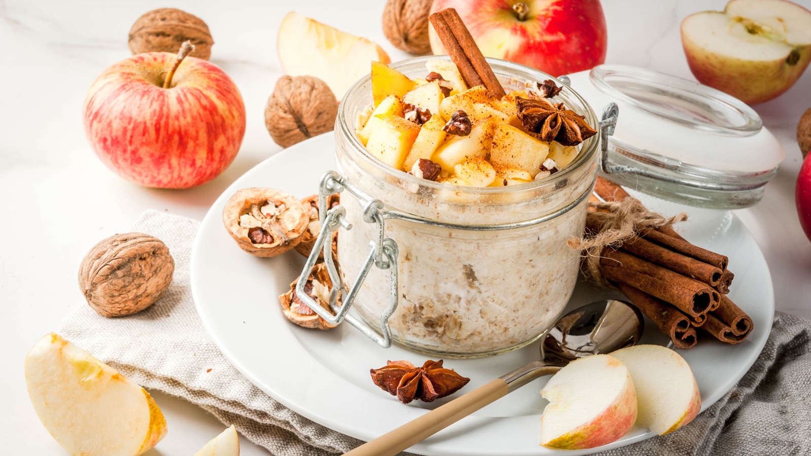 apple cinnamon overnight oats pictures with cinnamon sticks, walnuts and star anise