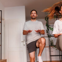 Image of a couple taking part in a home workout for beginners