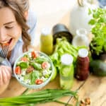 Image of a woman eating a healthy salad