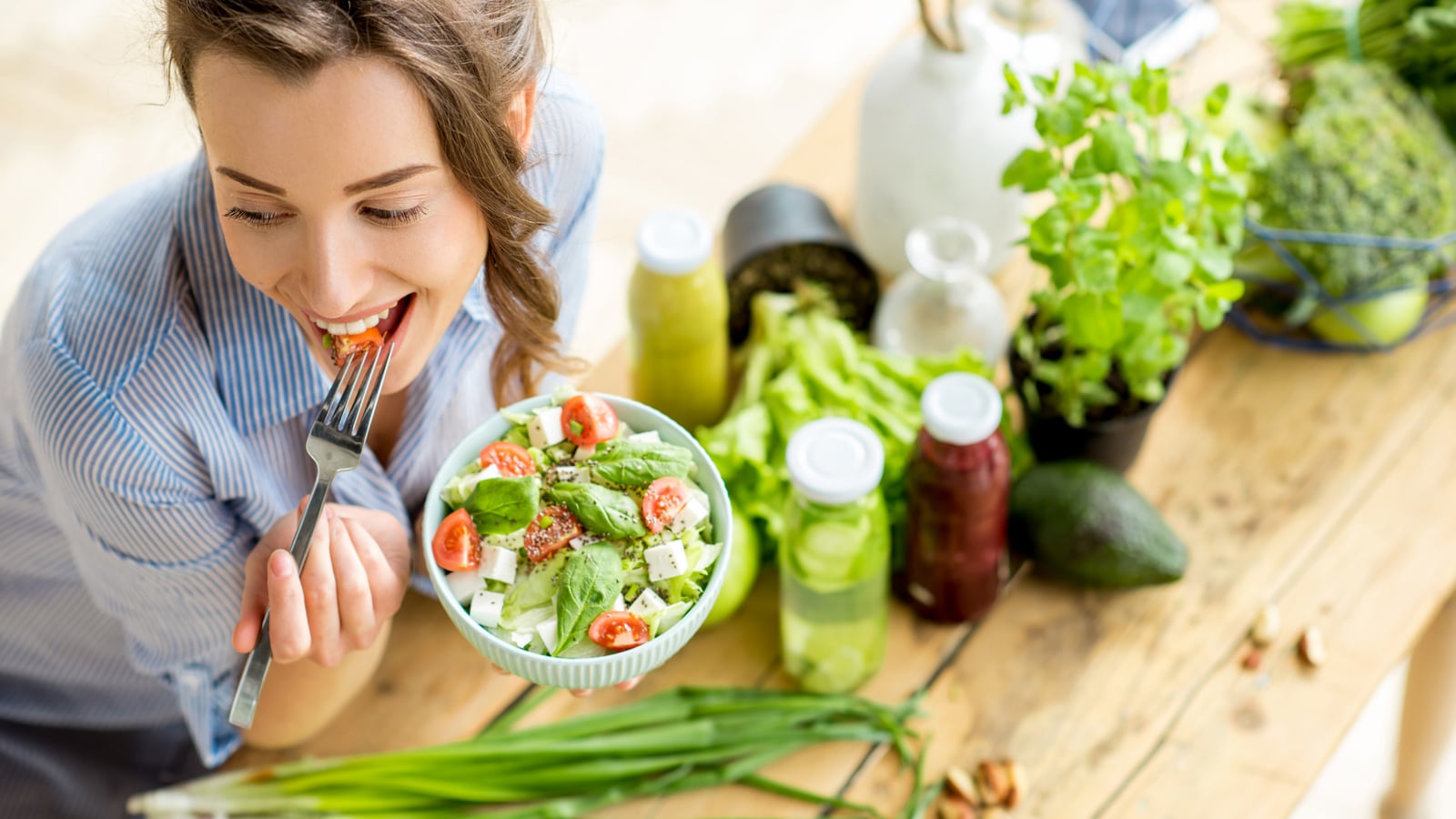 Image of a woman eating a healthy salad