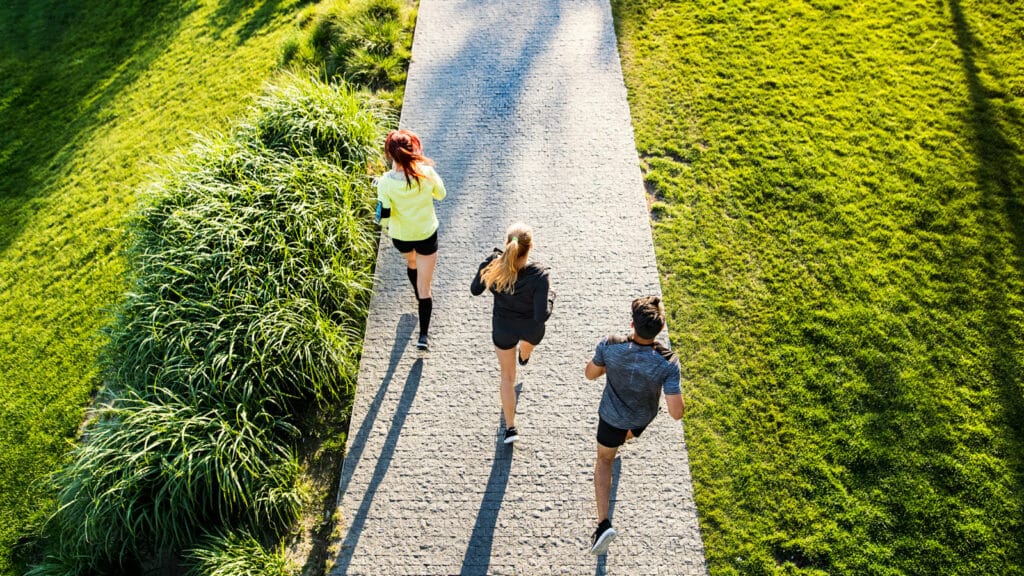 Image of three runners following an interval running workout