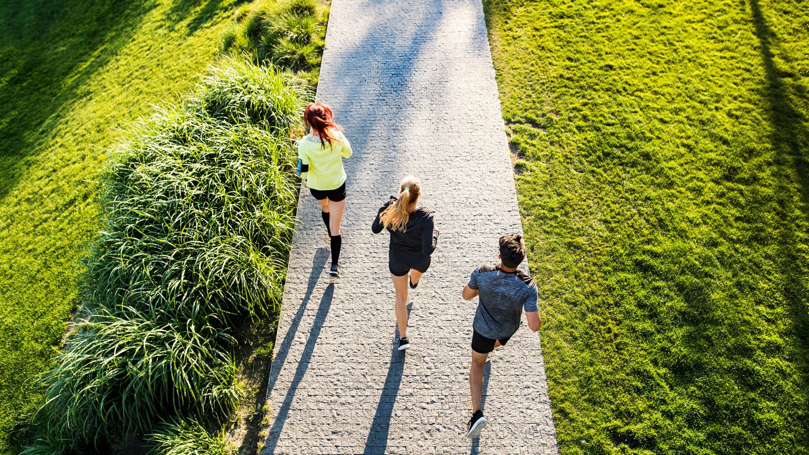 Image of three runners following an interval running workout