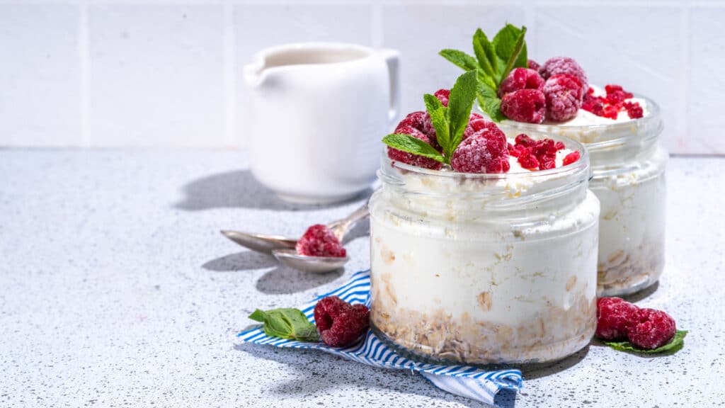 image of cheesecake overnight oats with raspberries