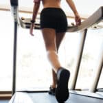 Image of a woman on a treadmill completing an inclined walking workout