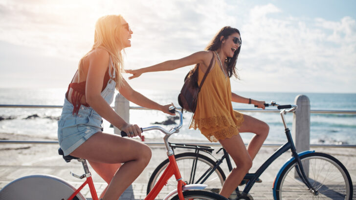 Image of two women riding bikes and having fun in the sunshine