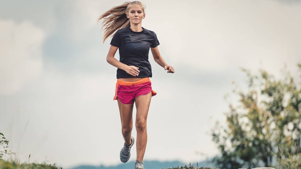 Image of a young female runner completing a hill repeat workout