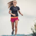 Image of a young female runner completing a hill repeat workout