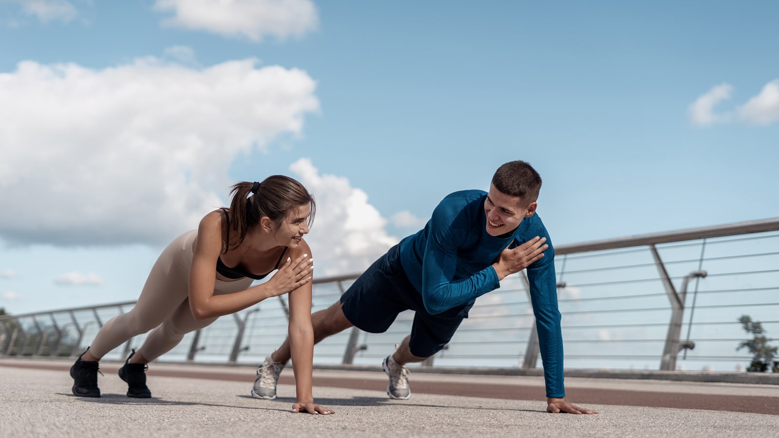 A young couple doing plank tap exercises together