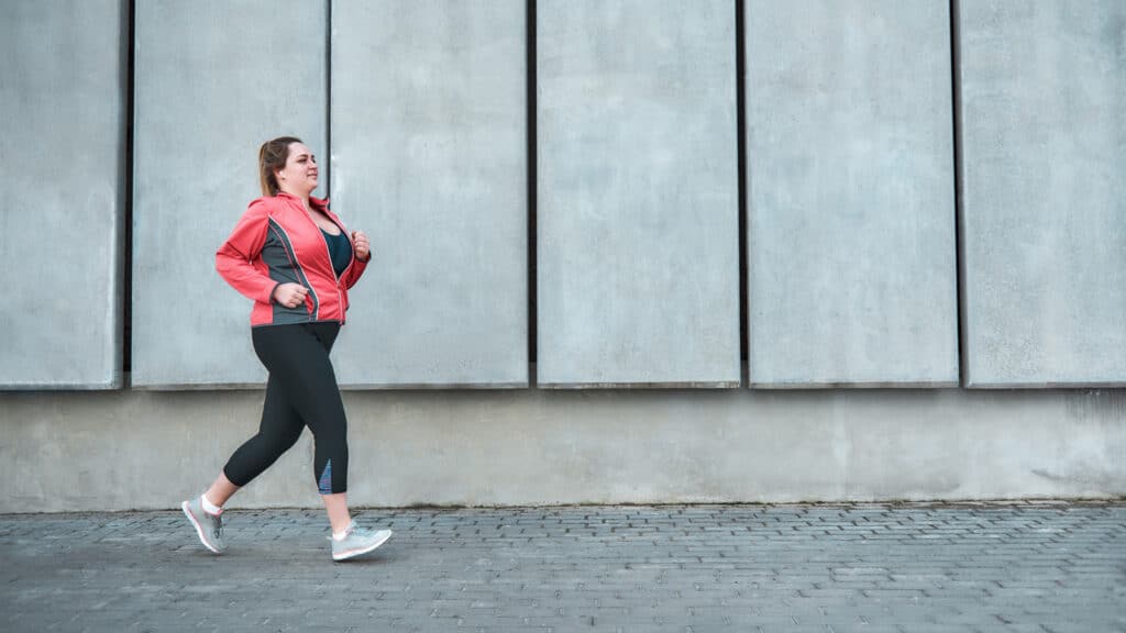 Image of a plus size woman walking to lose weight