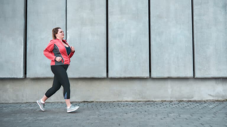 Image of a plus size woman walking to lose weight
