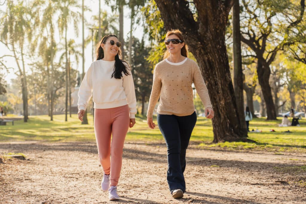 Image of two women walking in a park