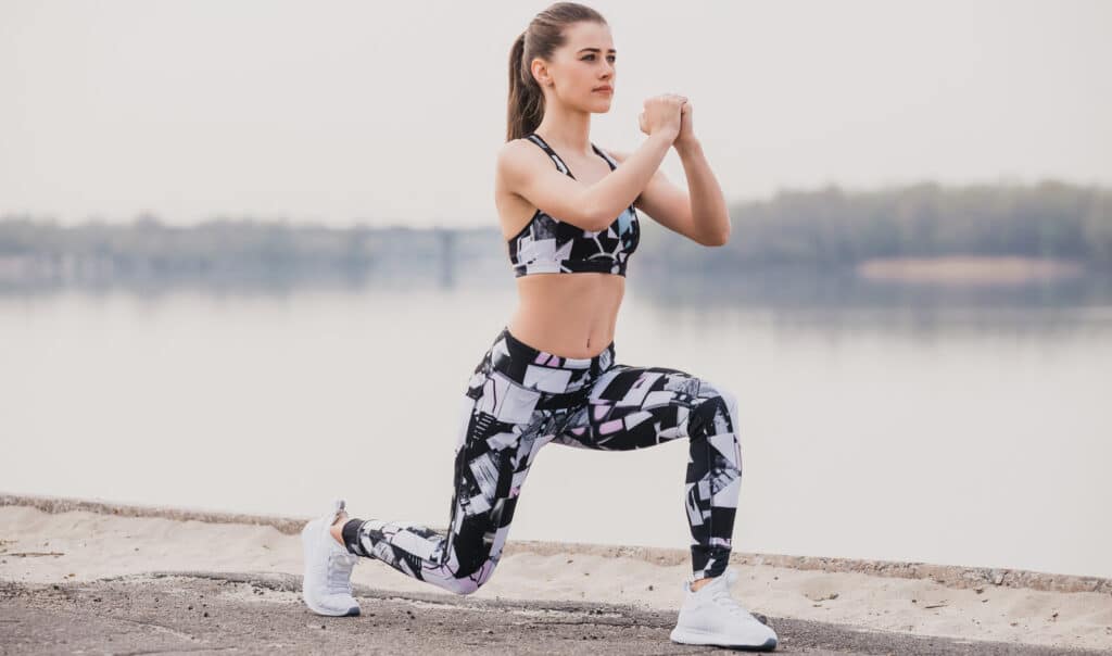 Image of a young woman doing walking lunges