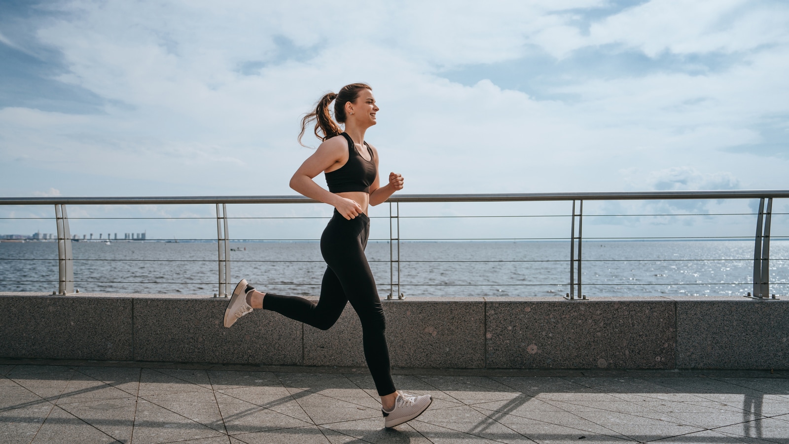 Image of a woman running a 5K along the seafront