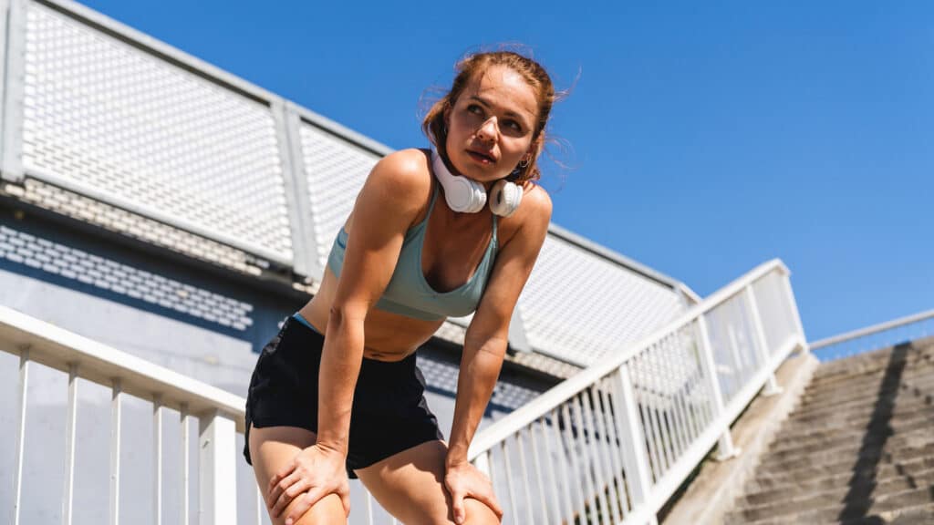Image of a tired female runner taking a break